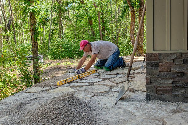 A man applying tools on a concrete patio, highlighting the work of professional concrete patio contractors.