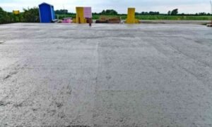 A concrete driveway contractors project featuring a durable parking lot with clearly marked yellow lines for vehicle guidance and proper organization.