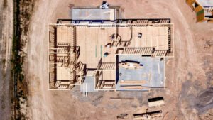 Aerial view of a house under construction, showcasing the framing and foundation work in San Rafael, CA.