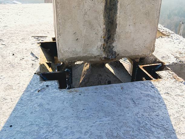 A concrete load-bearing pillar featuring a hole, indicating potential structural concerns.