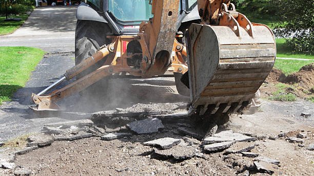 A bulldozer is engaged in road excavation as part of driveway repair efforts.